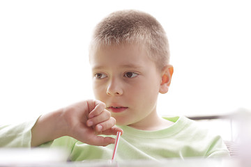 Image showing Kid at table in counterlight