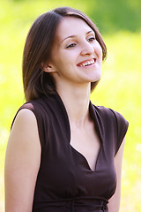 Image showing Smiling brunette in brown