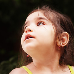 Image showing Little girl looks up