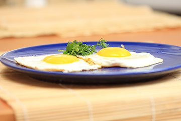 Image showing Blue plate with fried eggs