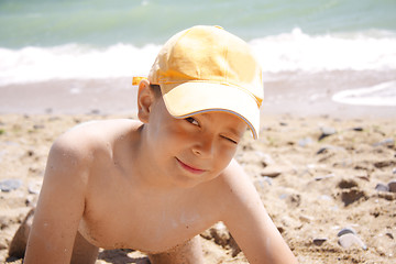 Image showing Squinting boy on beach