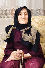 Image showing Senior woman counting beads