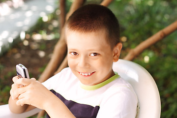 Image showing Boy with phone outdoor