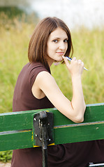 Image showing Woman sitting on bench