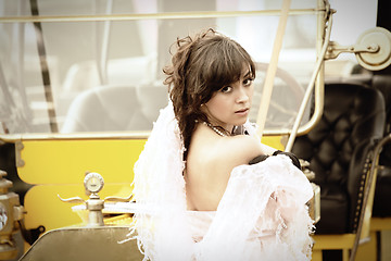 Image showing Young woman and yellow retro car