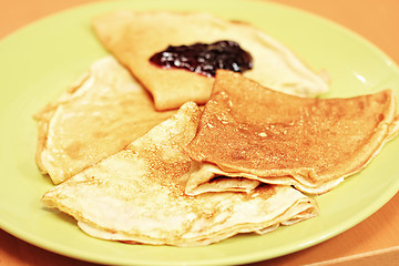 Image showing Pancakes with jam on green plate