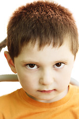 Image showing Very serious boy in orange