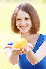 Image showing Woman passing orange