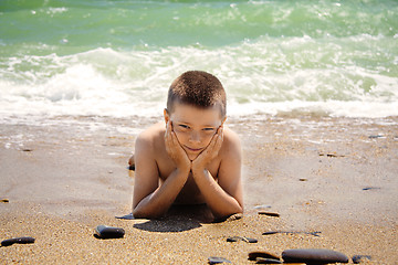 Image showing Boy laying on beach