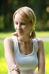 Image showing Blonde in park lost in thoughts