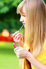Image showing Applying lipstick