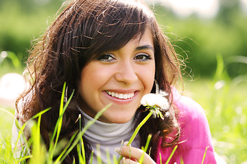 Image showing Smiling brunette with dandelion