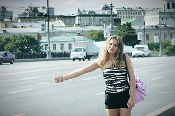 Image showing Hitchhiking girl with pink bag