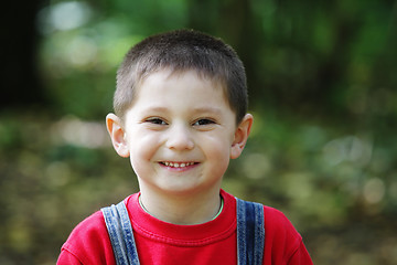 Image showing Smiling kid in red