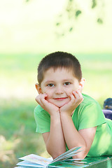 Image showing Cute boy laying down on bench