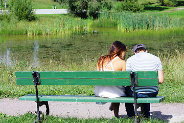 Image showing Couple sitting at pond