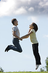 Image showing Jumping up to clouds