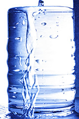 Image showing Water flows from glass