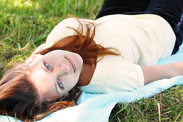 Image showing Girl laying on blue towel