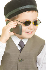 Image showing Kid in black cup calling on phone