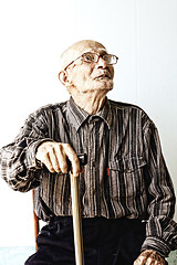 Image showing Senior man in eyeglasses looking up