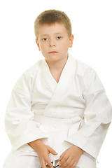 Image showing Serious karate kid sitting on knees