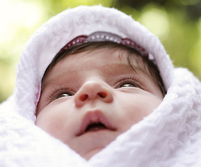 Image showing Baby in coverlet looking up