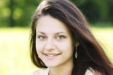 Image showing Smiling brunette with green eyes