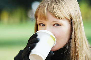 Image showing Blonde drinks outdoors