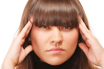 Image showing Serious brunette fingers at temples