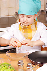 Image showing Little cook breaking egg