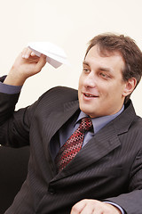 Image showing Smiling businessman with paper plane