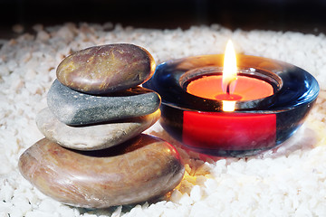 Image showing Stone cairn and flaming candle