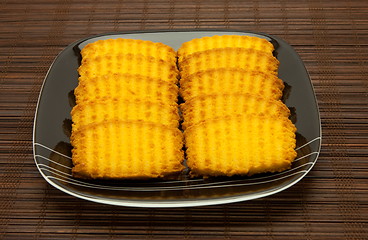 Image showing plate of cookies on dark brown background