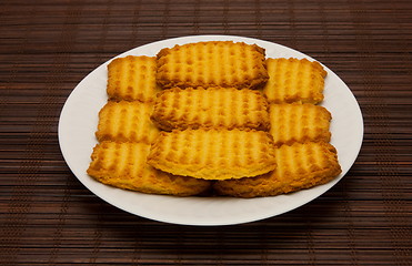 Image showing plate of cookies on dark brown background