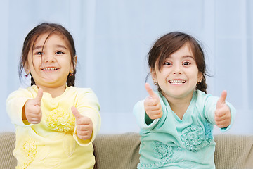 Image showing Little sisters thumbs up