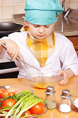 Image showing Little cook beating up eggs