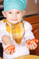 Image showing Little cook with cutted tomato