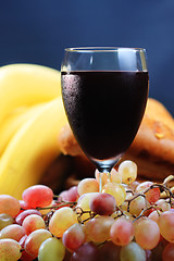 Image showing Red wine with bananas on background