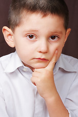 Image showing Serious boy in white shirt