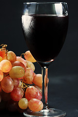 Image showing Glass of red wine and grapes