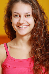 Image showing Toothy smiling girl in red