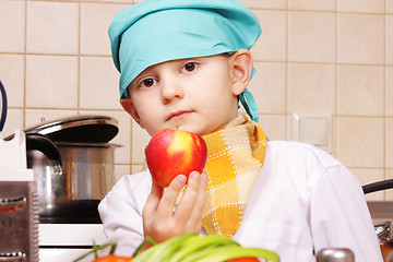 Image showing Little cook with red apple