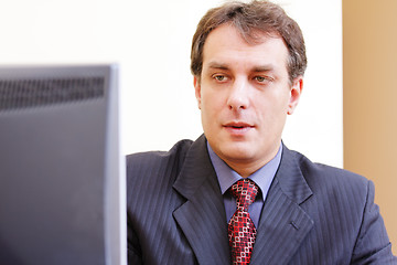 Image showing Businessman looking to monitor