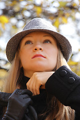 Image showing Blonde in hat adjusting sweater