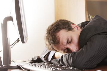 Image showing Businesman sleeping on workplace