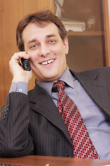 Image showing Smiling businessman on phone