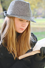 Image showing Woman in hat reading