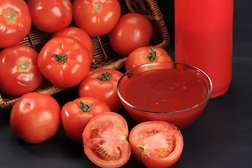 Image showing Tomatoes from basket and ketchup