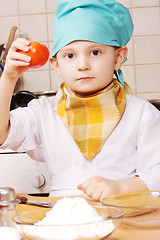 Image showing Little cook with tomato